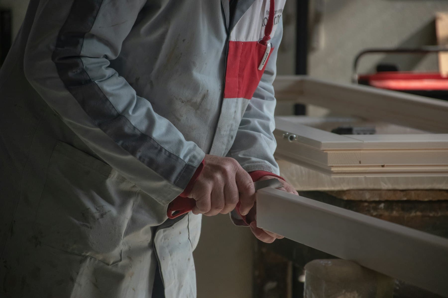 A craftsman finishing bespoke joinery for a InteriorMan project